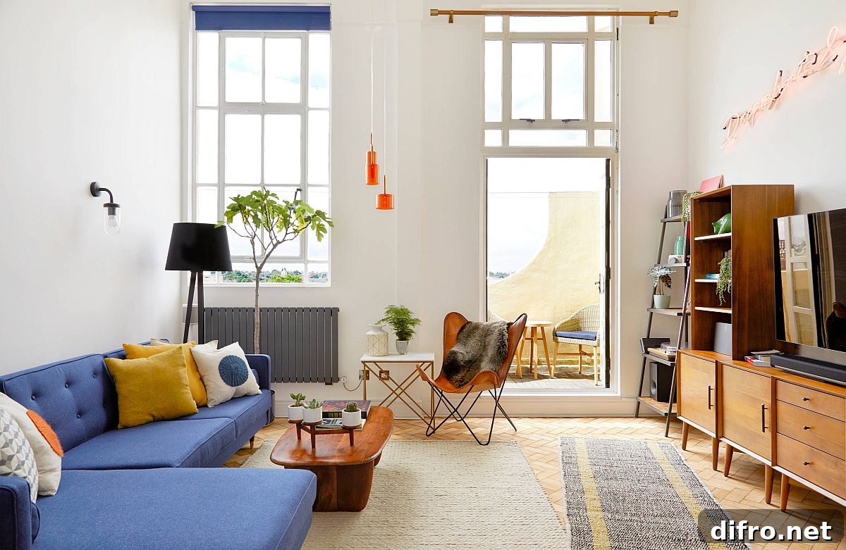 Smart midcentury modern living room with blue couch and yellow accent pillow