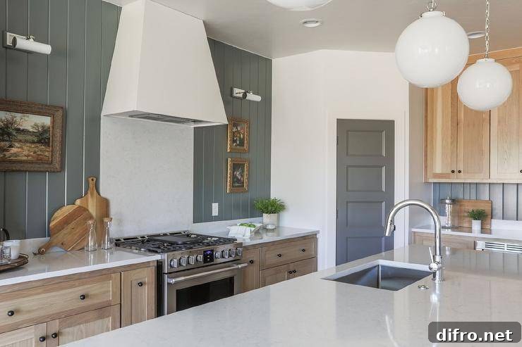 Cottage kitchen with shiplap wall trim and marble topped island.