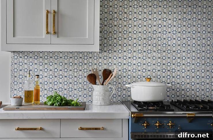 White cabinets with a blue-and-gray mosaic backsplash and a blue stove.