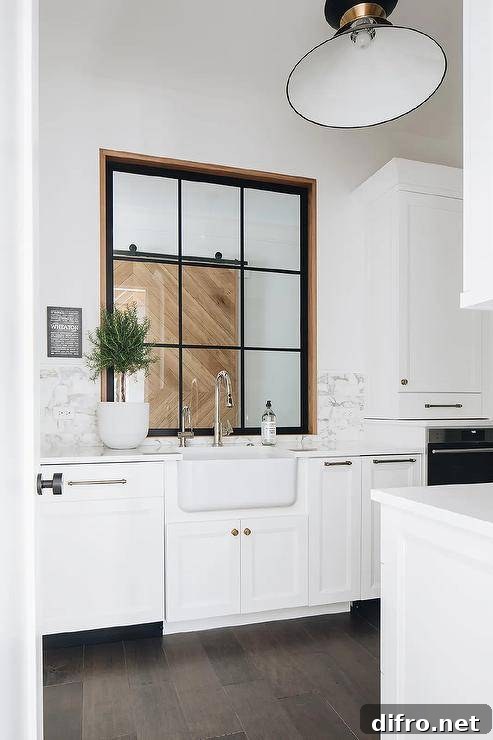 Marble backsplash above a farmhouse sink and white cabinets.
