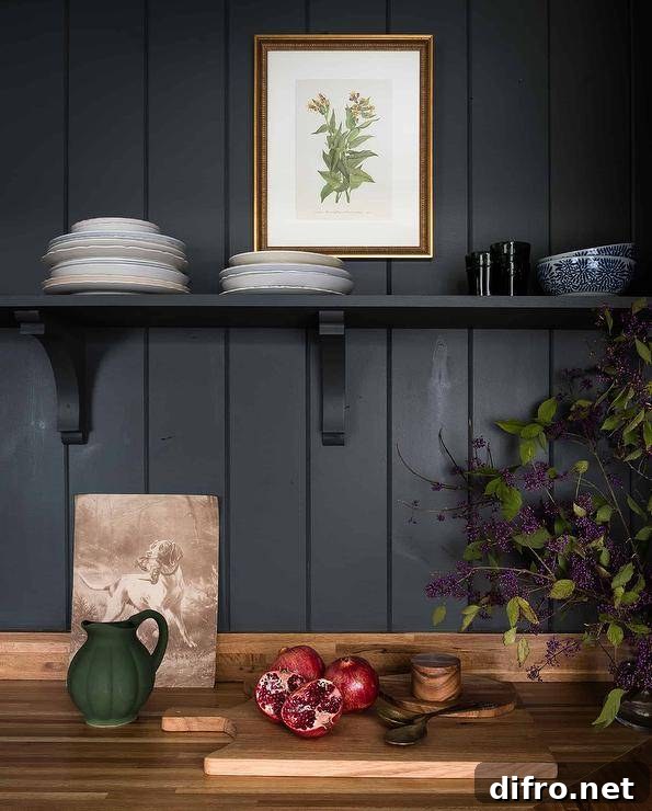 Black shiplap wall with a black shelf above a wooden countertop.