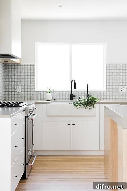 Gray grid backsplash tiles framing a window above a farmhouse sink.