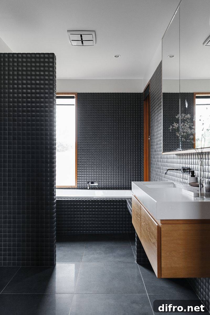Modern bathroom in dark gray with floating wooden vanity and a white countertop and sink