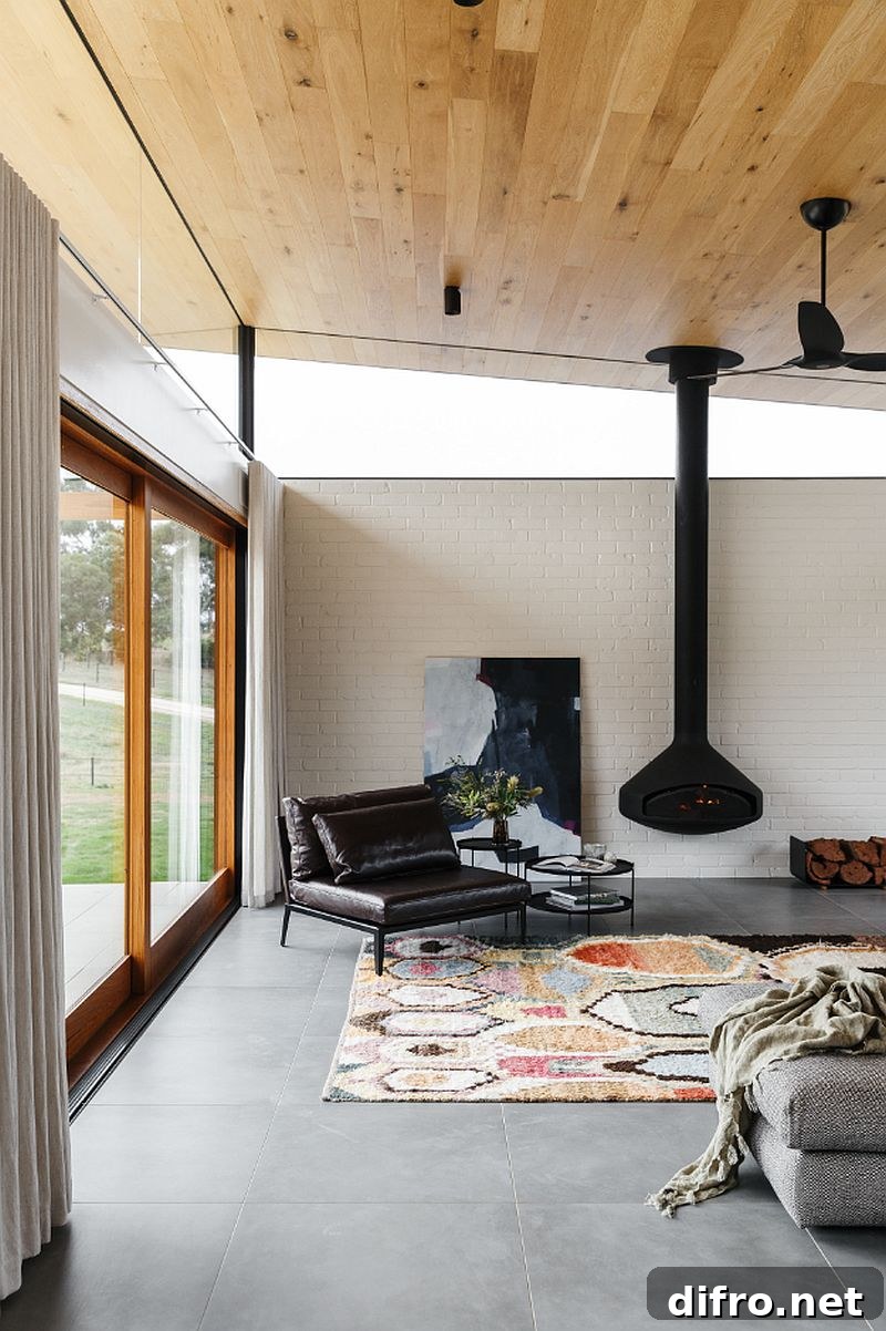 Brick wall in white along with a sloped wooden ceiling for the classic living room