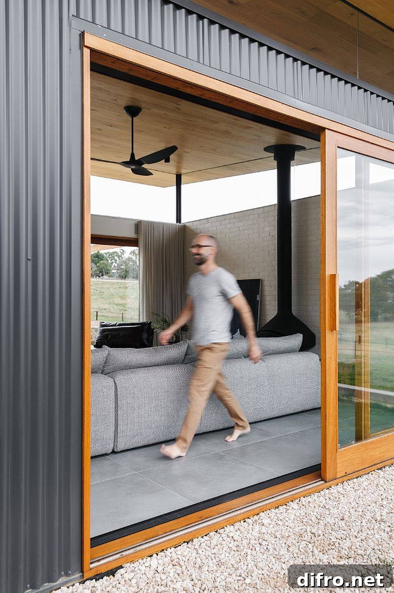 Sliding doors with wooden frame connect the new living room with the world outside