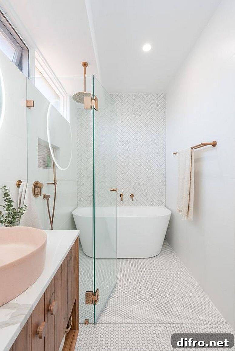 White bathroom with herringbone pattern and pastel pink sink