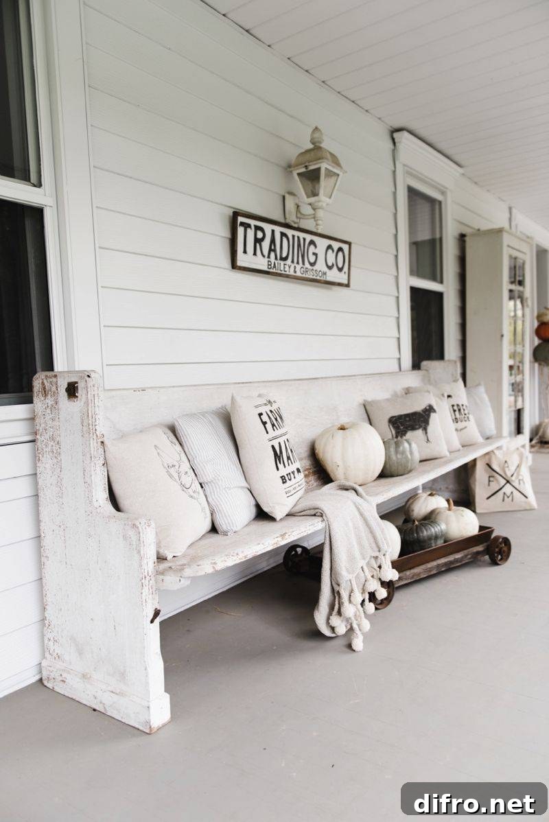 Antique Wooden Bench with Earth Toned Pillows