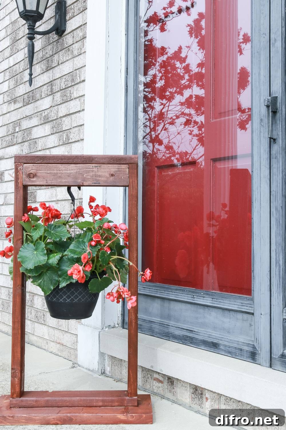 Red flowers hanging on a wood stand
