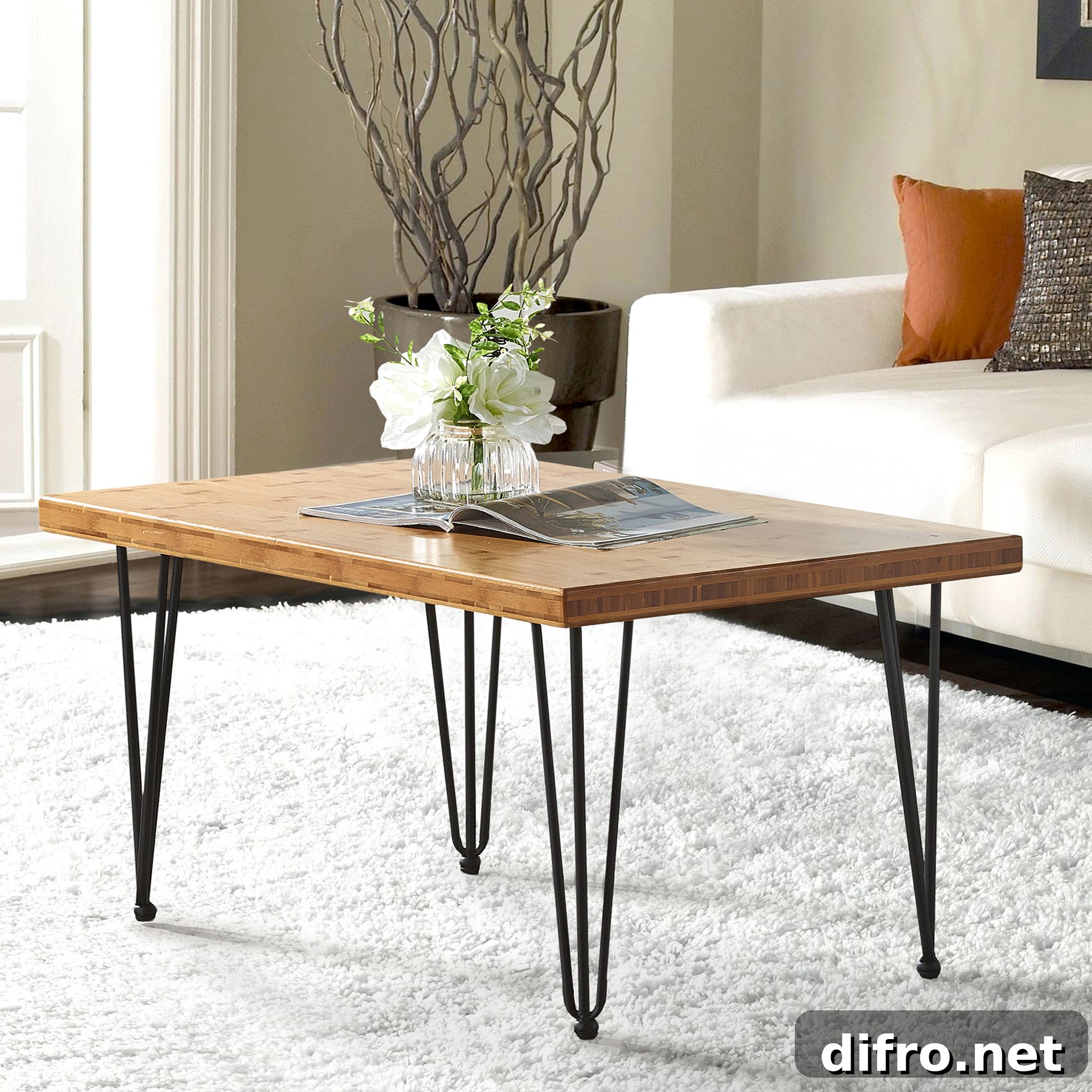 White flowers and open magazine on wood center table with thin metal legs