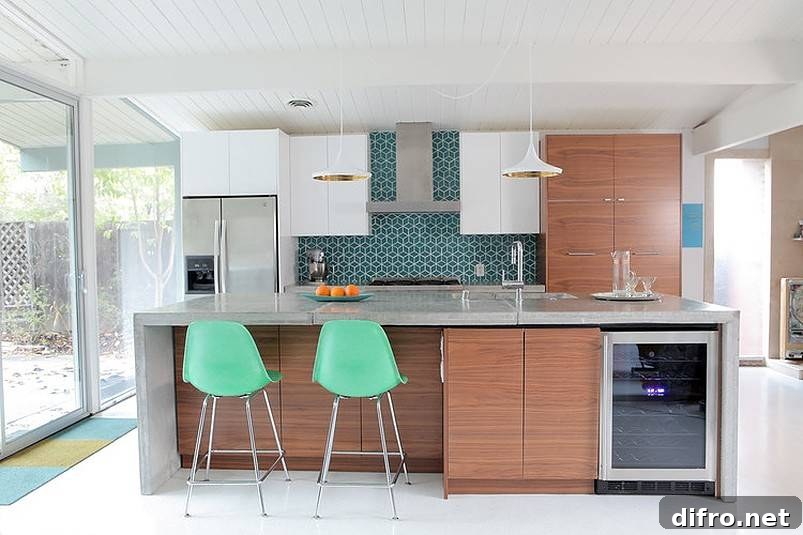 Three oranges on countertop with two mint green chairs