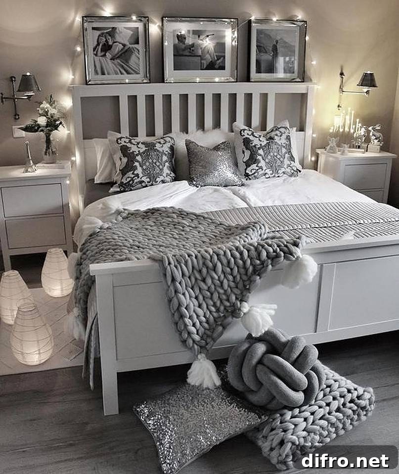 White and grey bed with string lights and pictures at the head