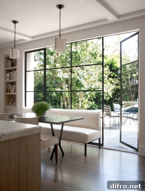 Floor-to-Ceiling Windows to Maximize Natural Light and Space 14 Modern kitchen with windows that open to the backyard.