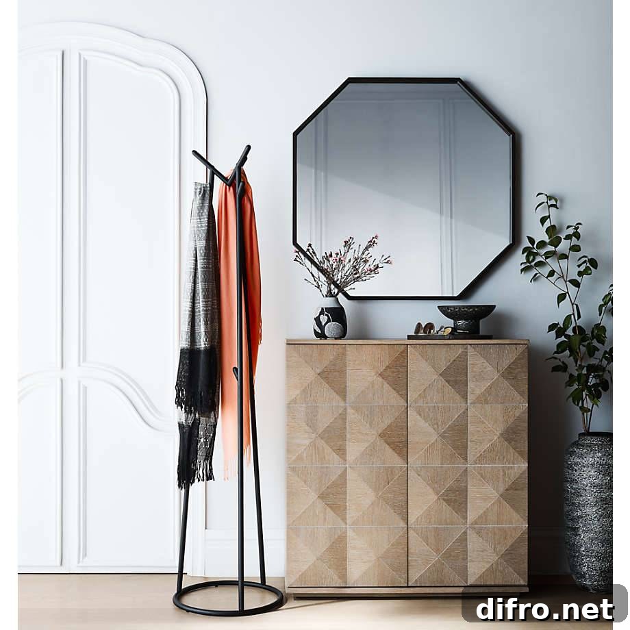 Two shawls hanging on coat tree beside a large mirror