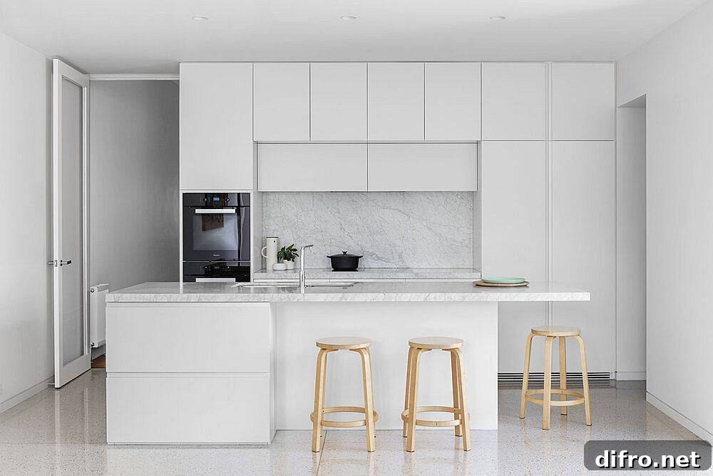 All-white modern kitchen design idea with stone countertops and polished shelves