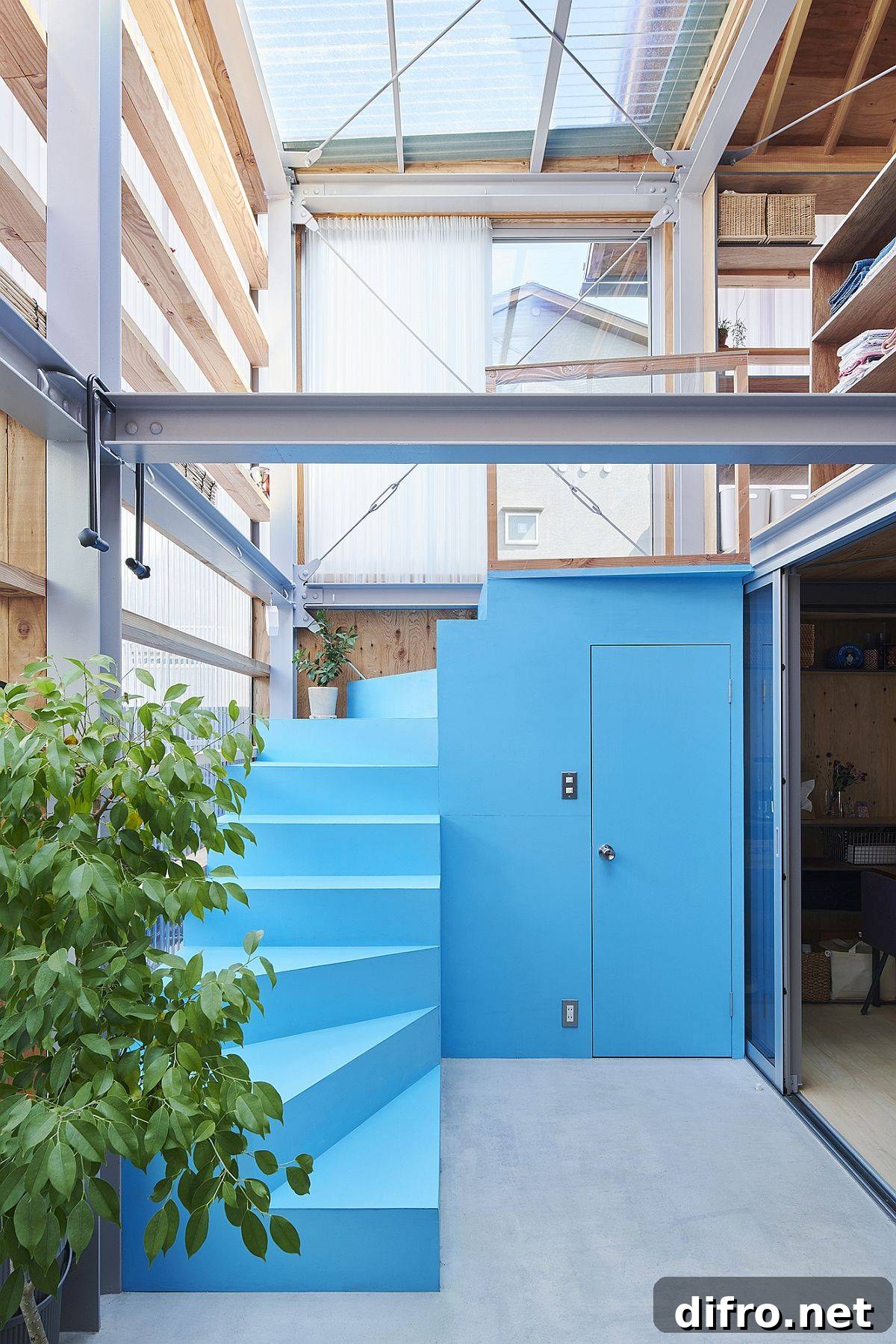 Adaptable Metal-Frame Japanese Home with Movable Walls 9 Custom blue staircase to the upper level