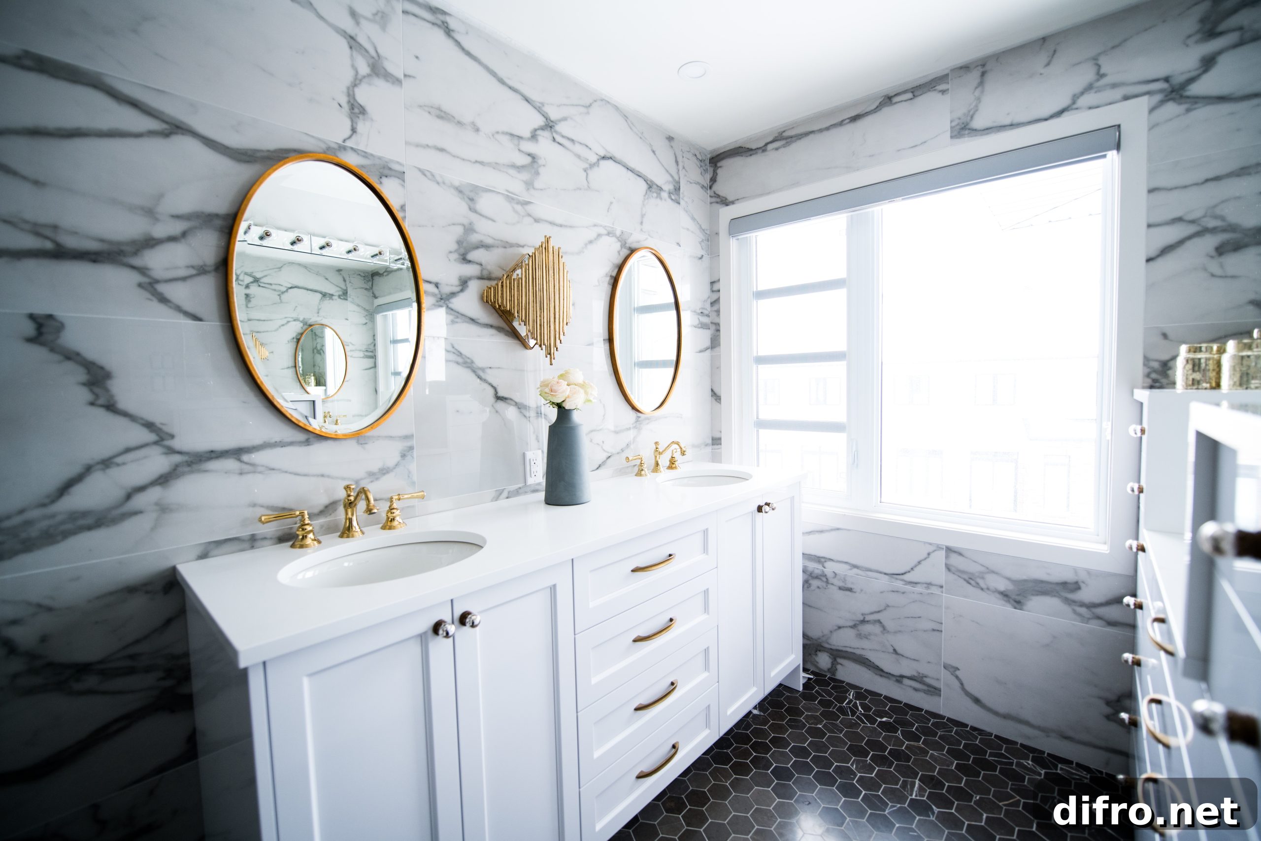 Two large mirrors and white double vanity inside bathroom