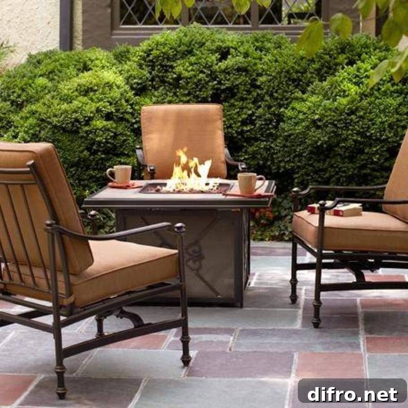 lit firepit with beige chairs surrounding on patio