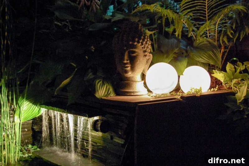 glowing orb lantern next to head sculpture and water feature