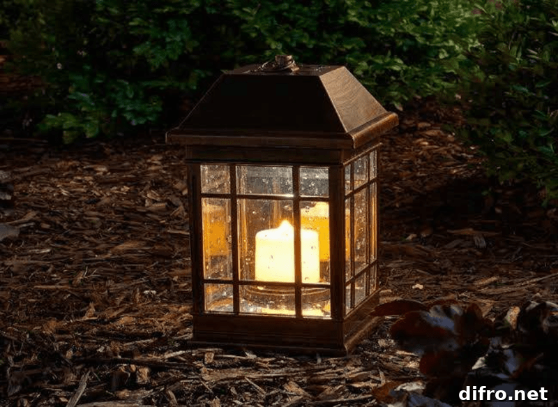black rod iron lit lantern on ground