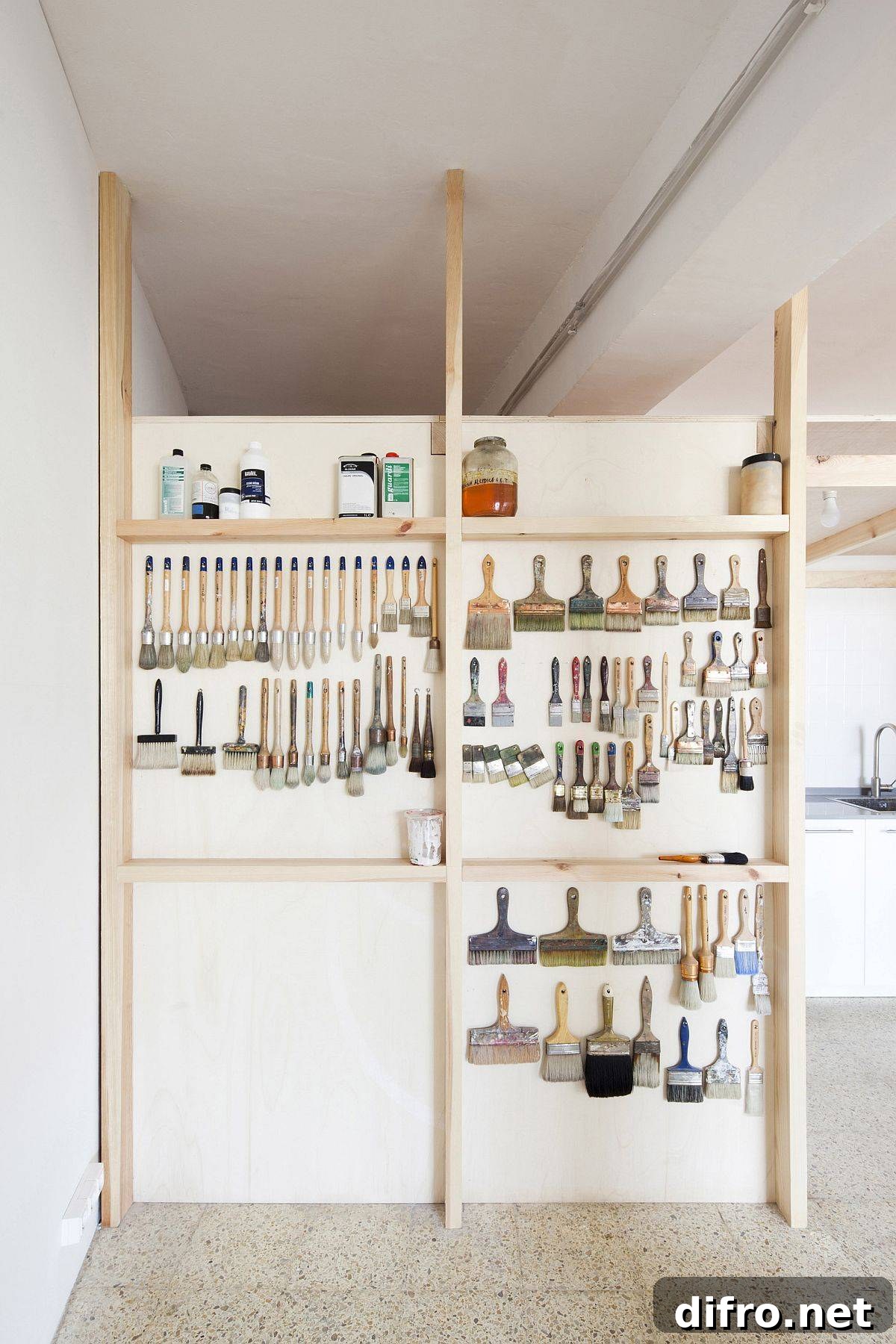 Wooden wall with hooks and storage for studio hardware