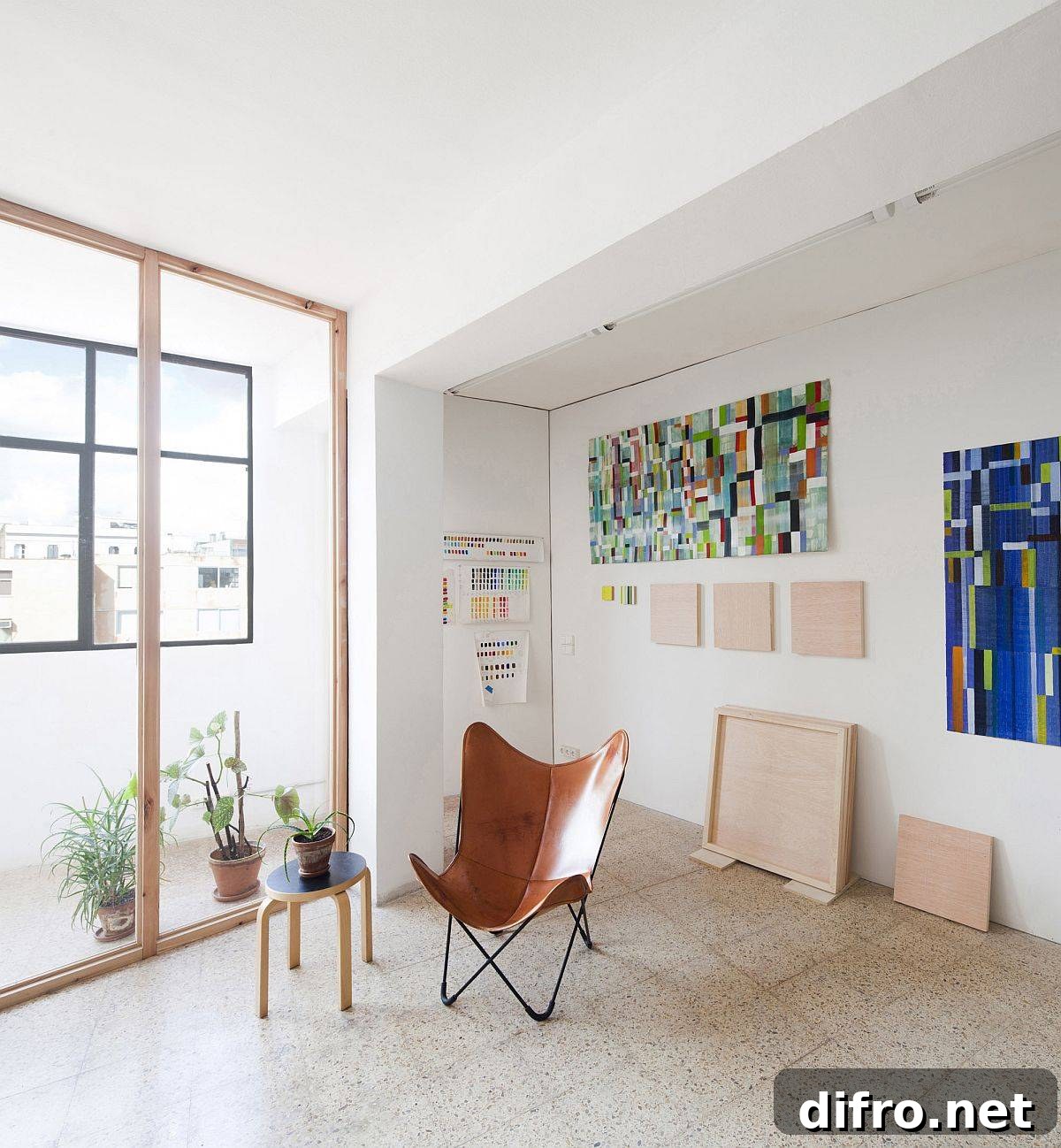 Studio interior with wall art and leather Butterfly chair