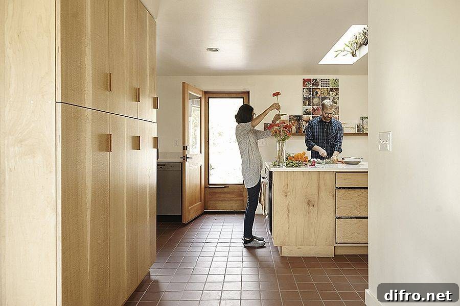 Kitchen and dining area opening toward the courtyard through large windows