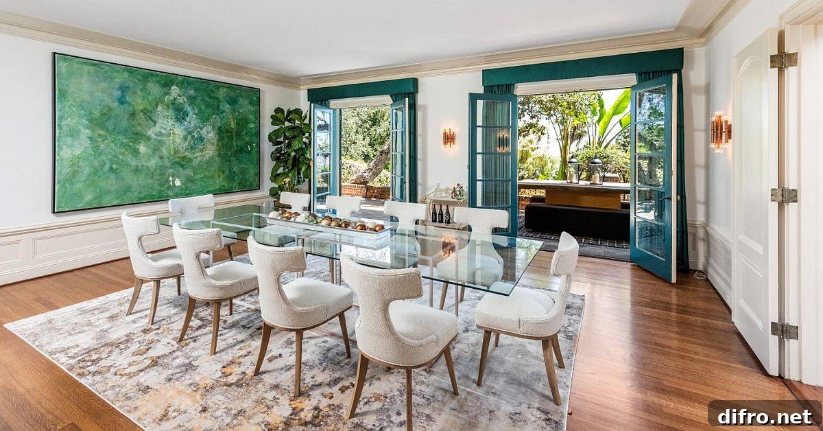 Modern dining room with glass table and green artwork