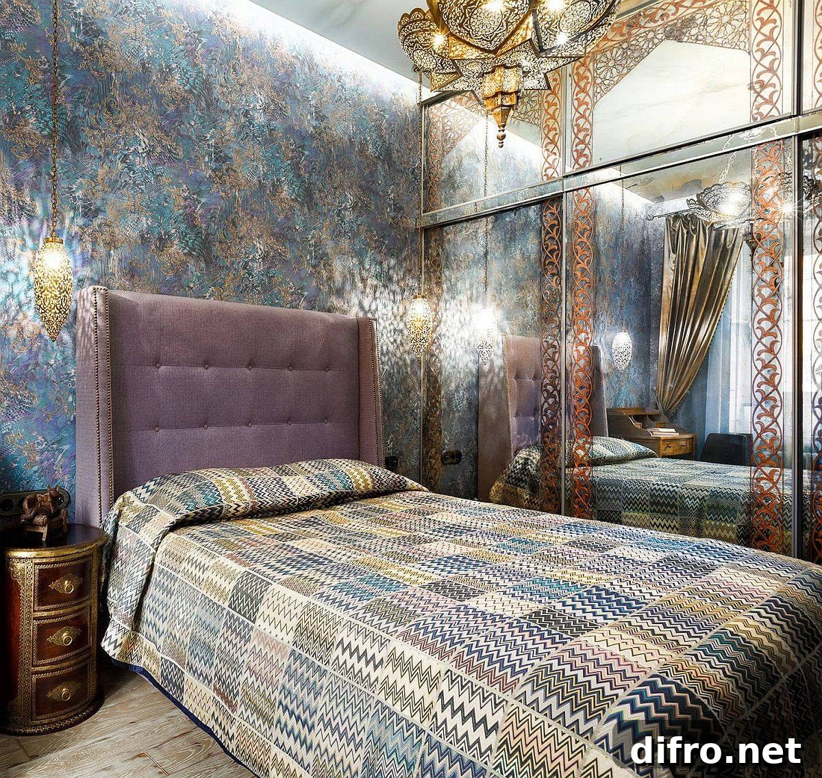 Mirrored wardrobe and dazzling wallpaper create a small Mediterranean bedroom