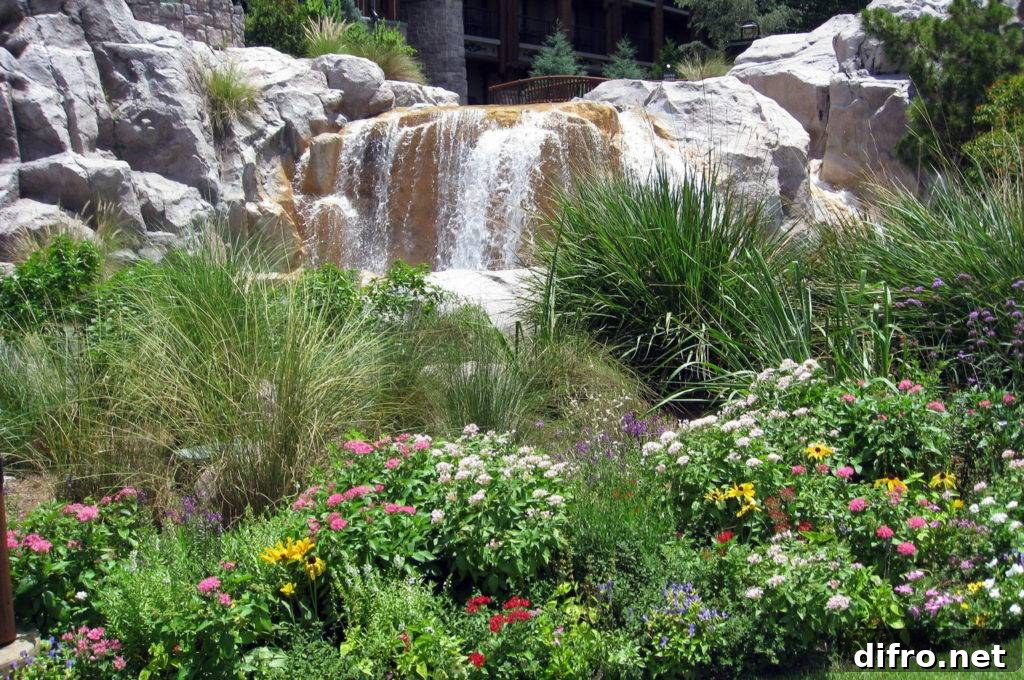 Softscape plants and flowers combine with hardscape stone waterfall feature