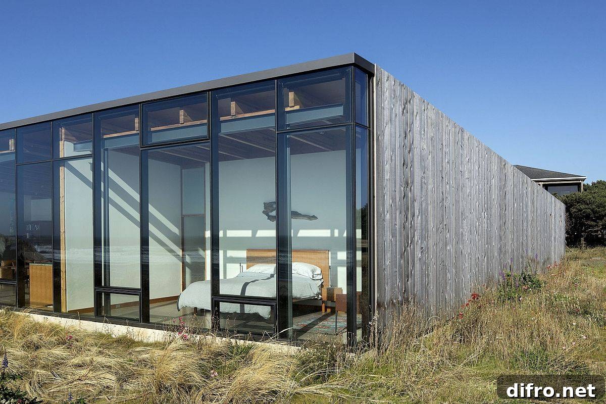 Wall of glass doors and floor-to-ceiling glass windows opens up the bedrooms to spectacular beach views