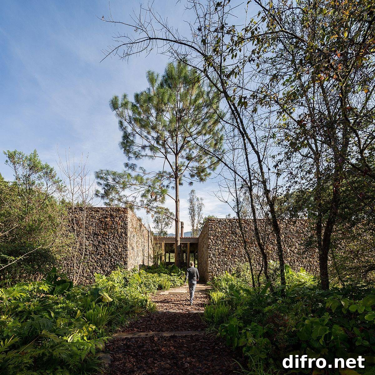 Lovely natural forest and stone wall-clad entryway leads to the lovely villa in Valle de Bravo