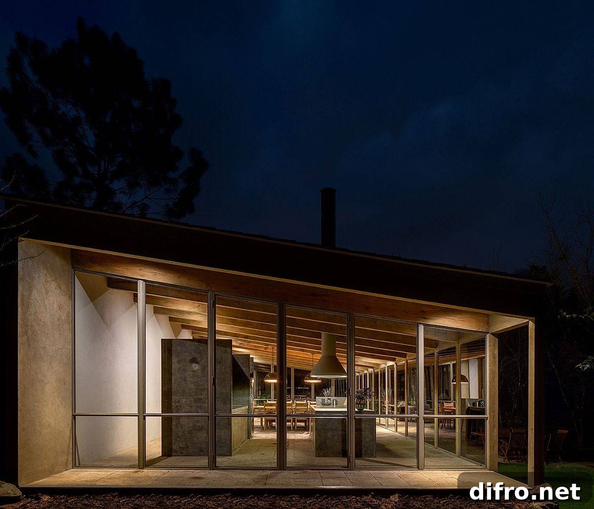 Sloped ceiling of the home is even more prominent after sunset thanks to warm lighting