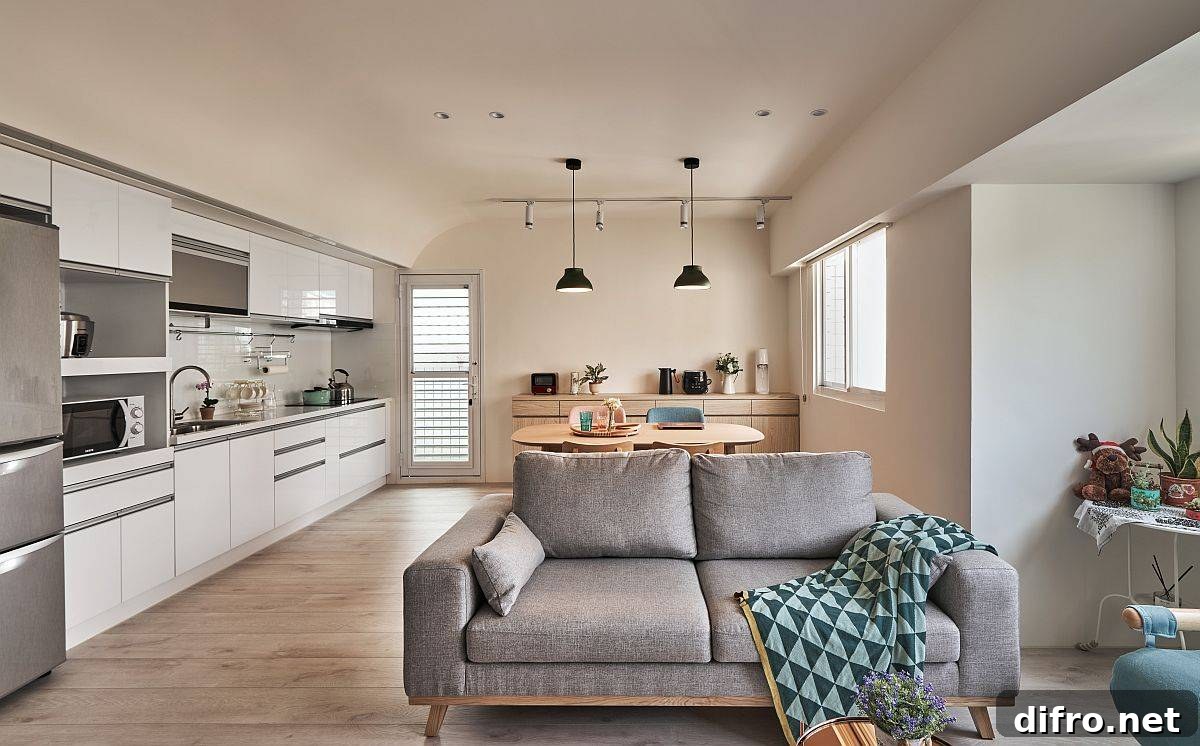 Single-wall kitchen with compact dining area beside it in a modern Taipei apartment