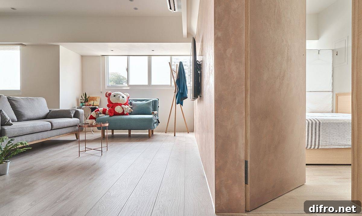 Seamless transition from living area into the bedroom in a compact apartment layout