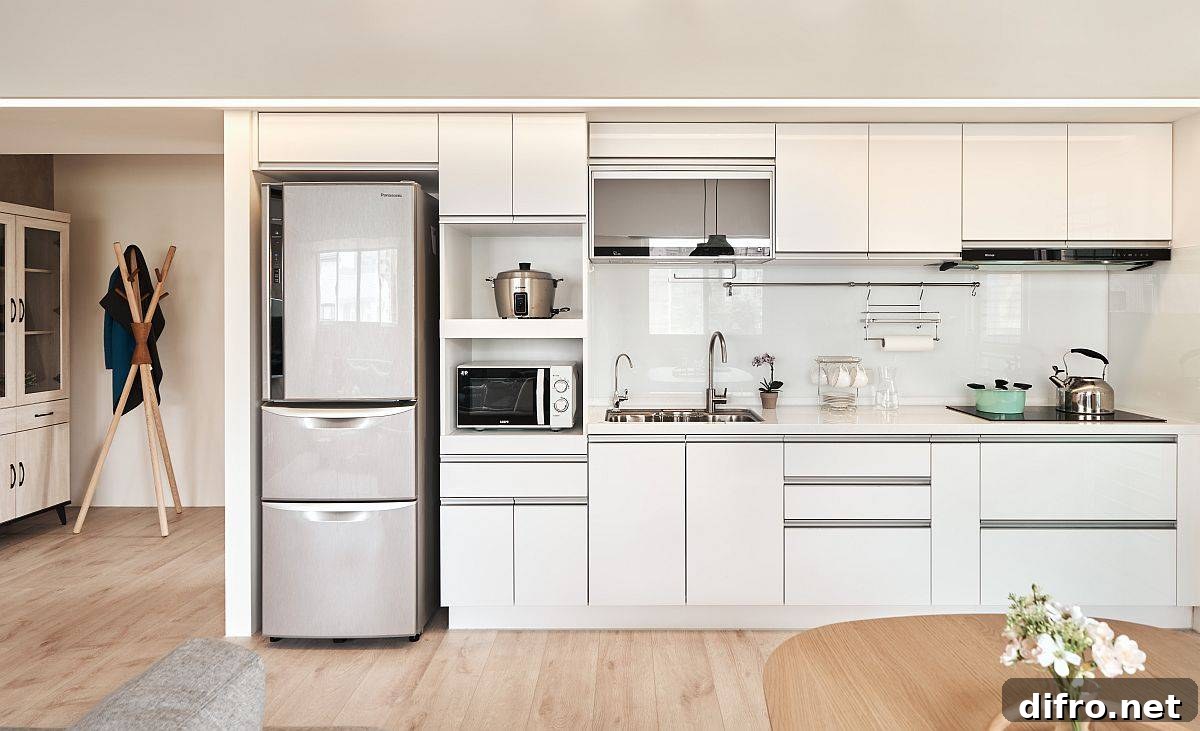 Smart single-wall kitchen in white with ample storage for a small apartment