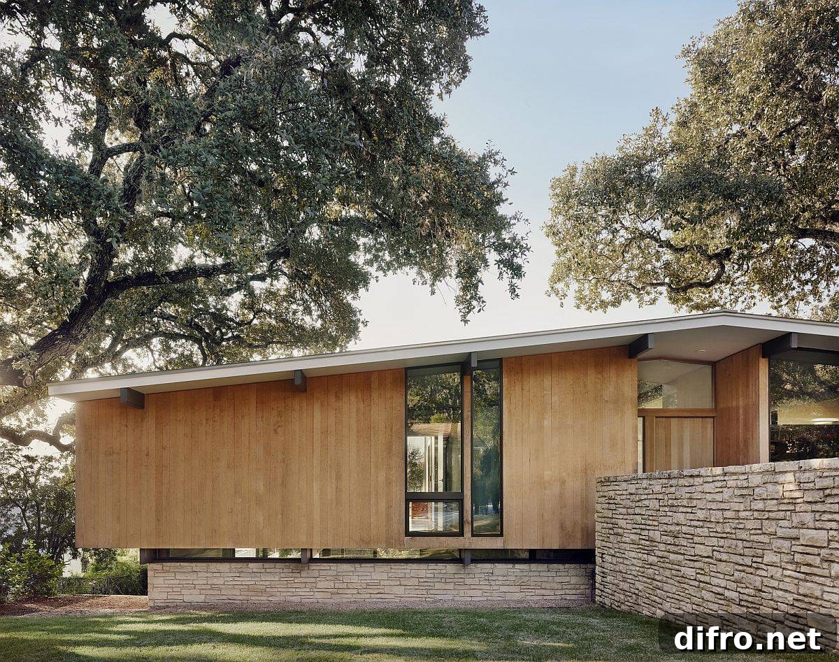 Limestone base and pitched roof of the revamped modern Texas home