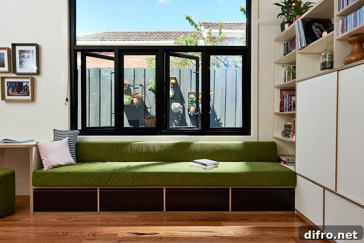 Green built-in bench overlooking the outdoors in Northcote family room