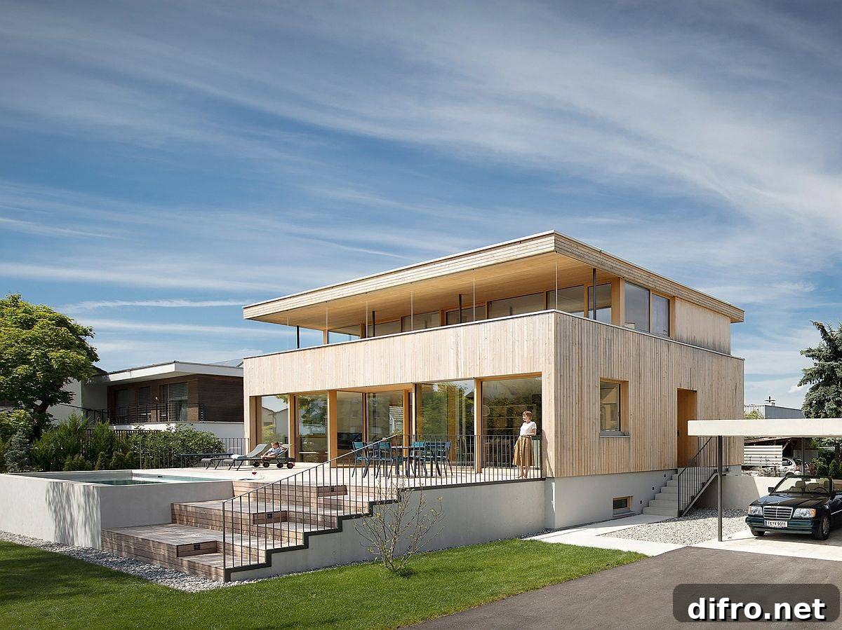 Rear facade, pool and deck of contemporary home in Austria with a wooden exterior