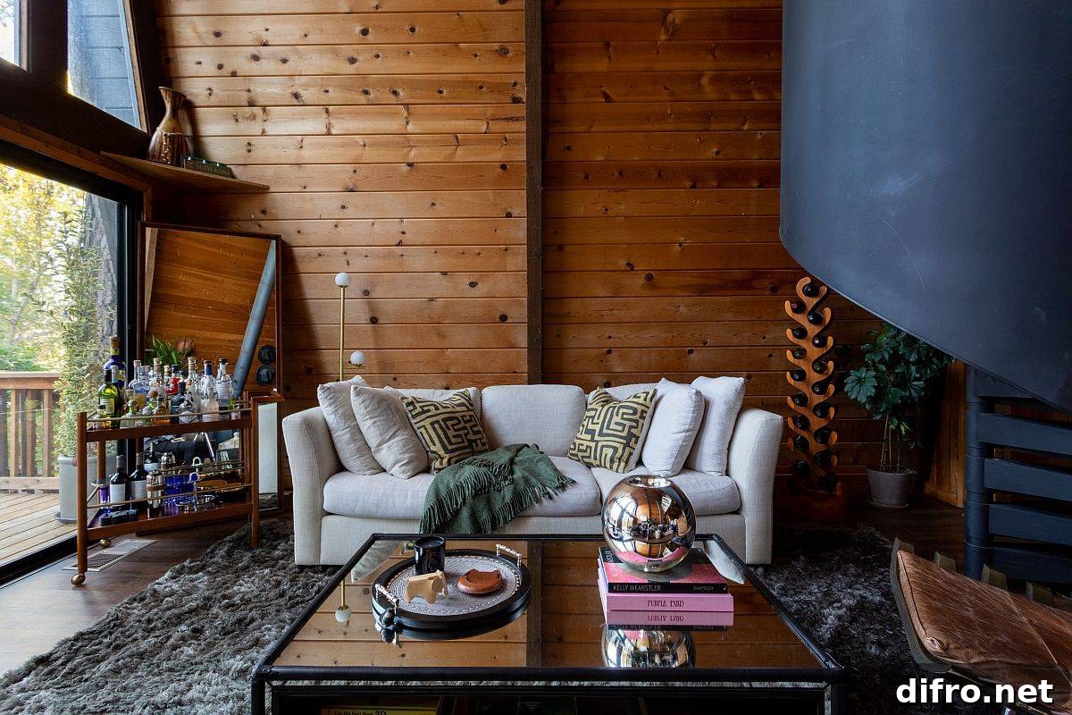 Modern rustic living room with woodsy backdrop and a comfy white couch