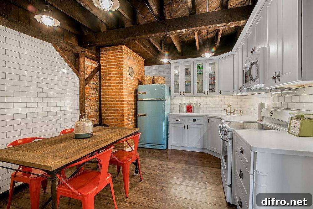 Bright red chairs and vintage refrigerator in a small farmhouse kitchen