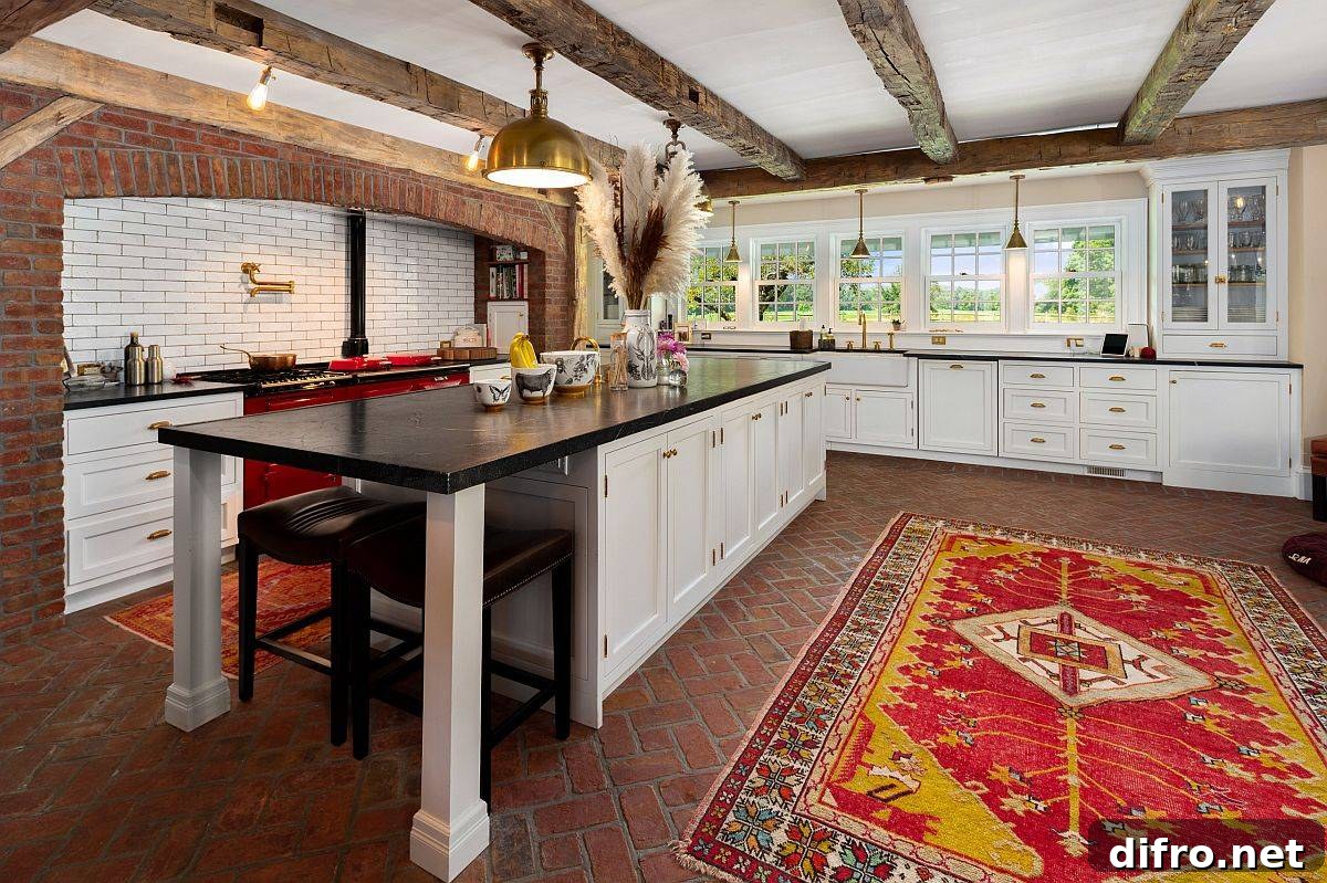 Spacious kitchen with brick walls and colorful rug