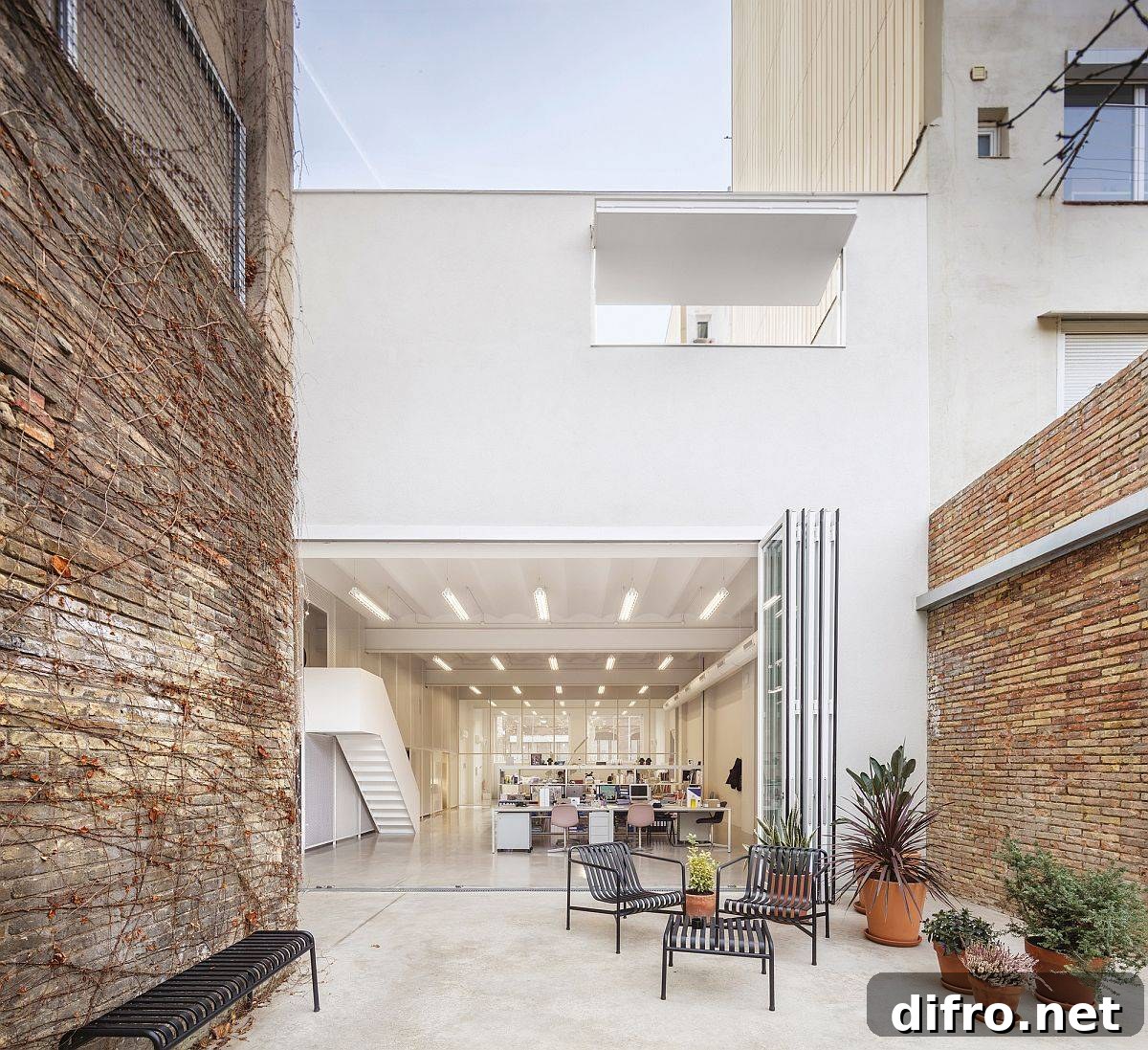 Bifolding glass doors connect the office interior with the relaxing external spaces