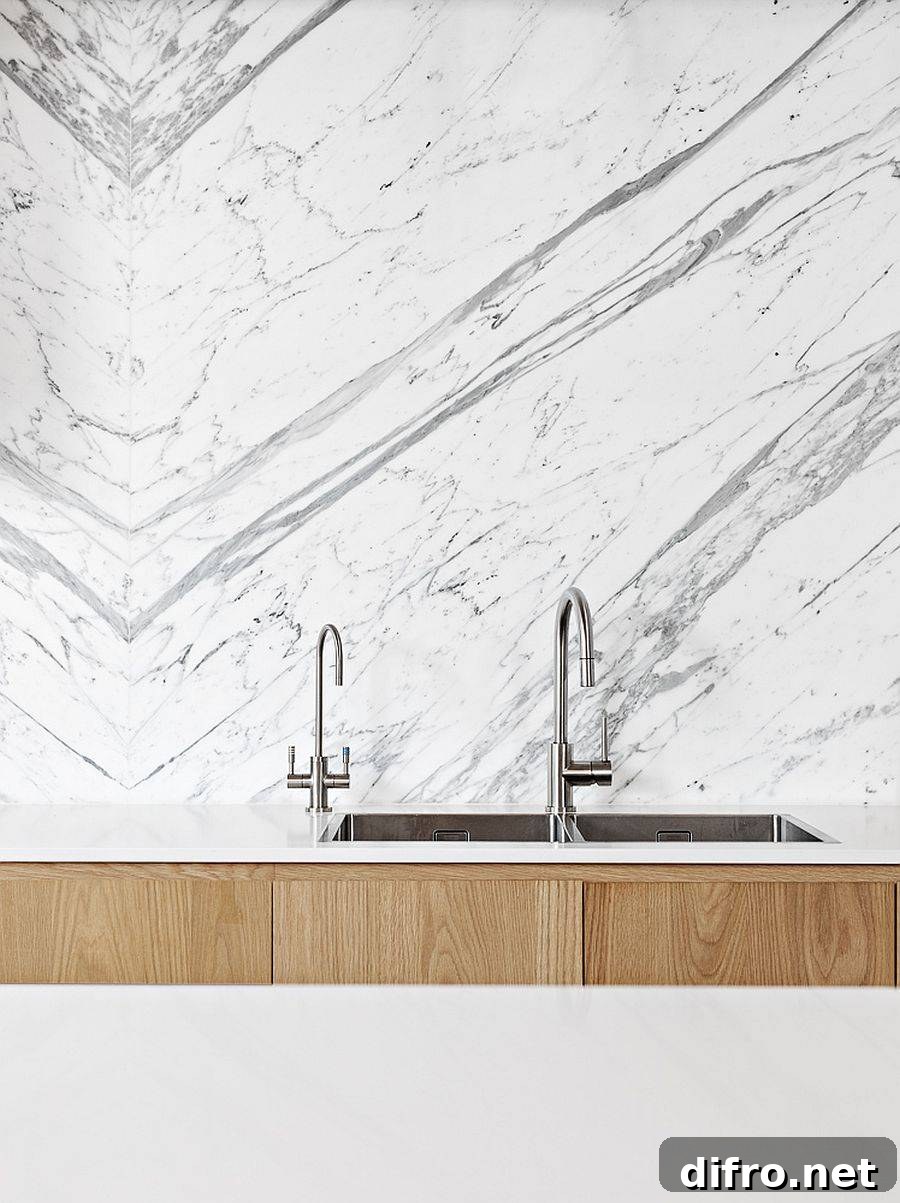 Marble backsplash and polished fixtures in contemporary kitchen