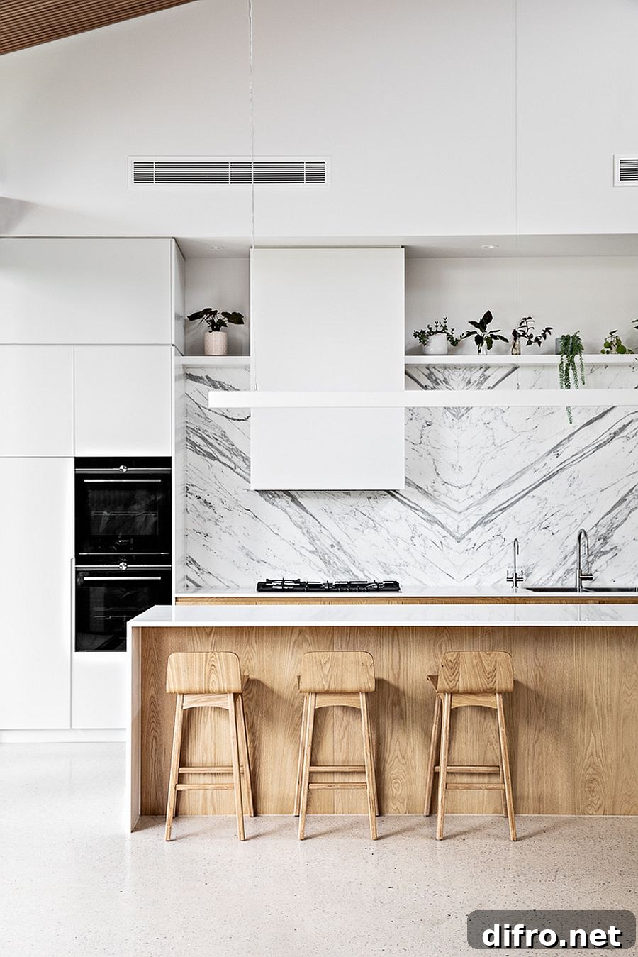 White marble backsplash with wooden cabinets and island