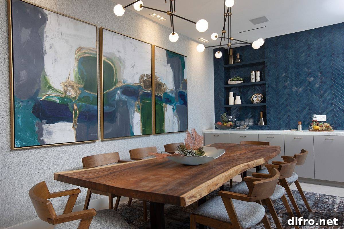 Striking wall art in a dining room with blue background and wooden table
