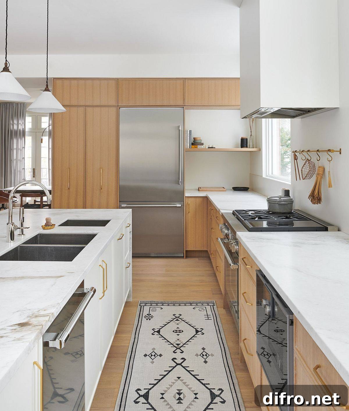 White marble countertops complement the wood cabinets beautifully in this kitchen