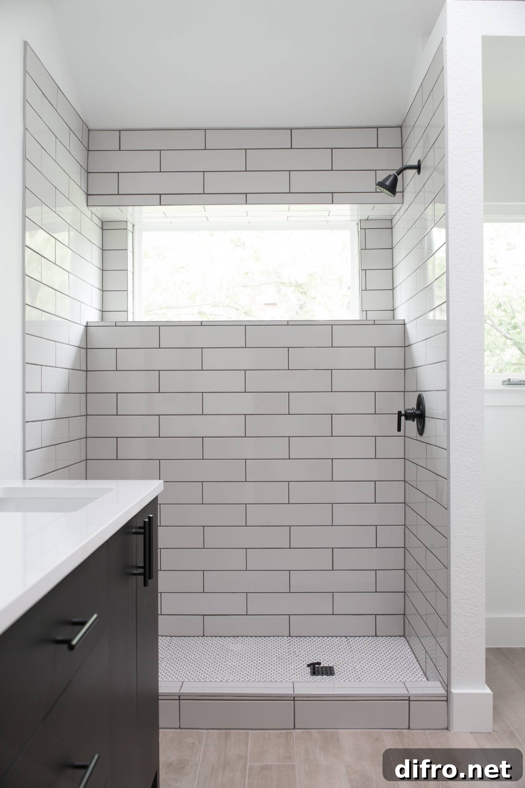 window in bathroom above white tiled wall