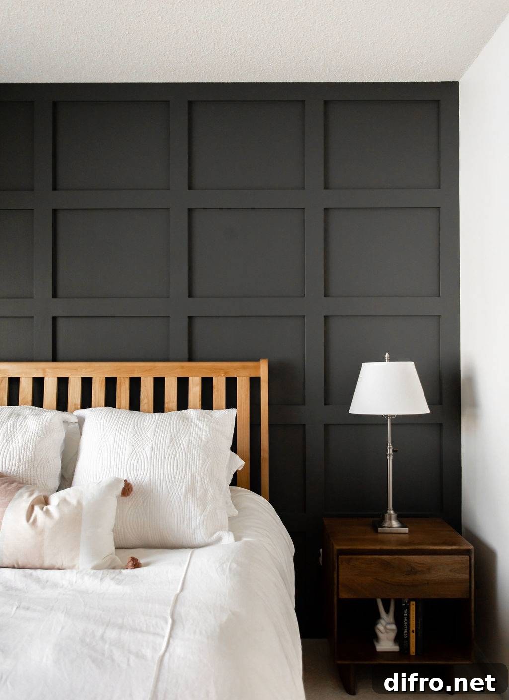 Dark moody bedroom with black board and batten accent wall