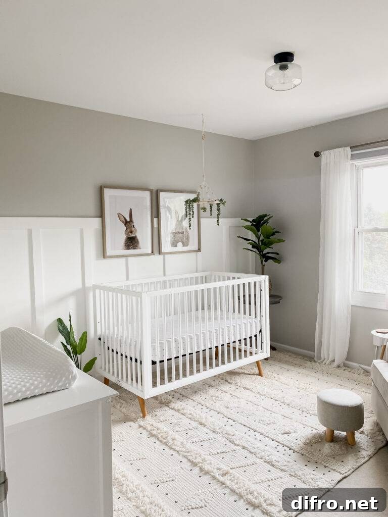 Nursery featuring taupe paint with white board and batten