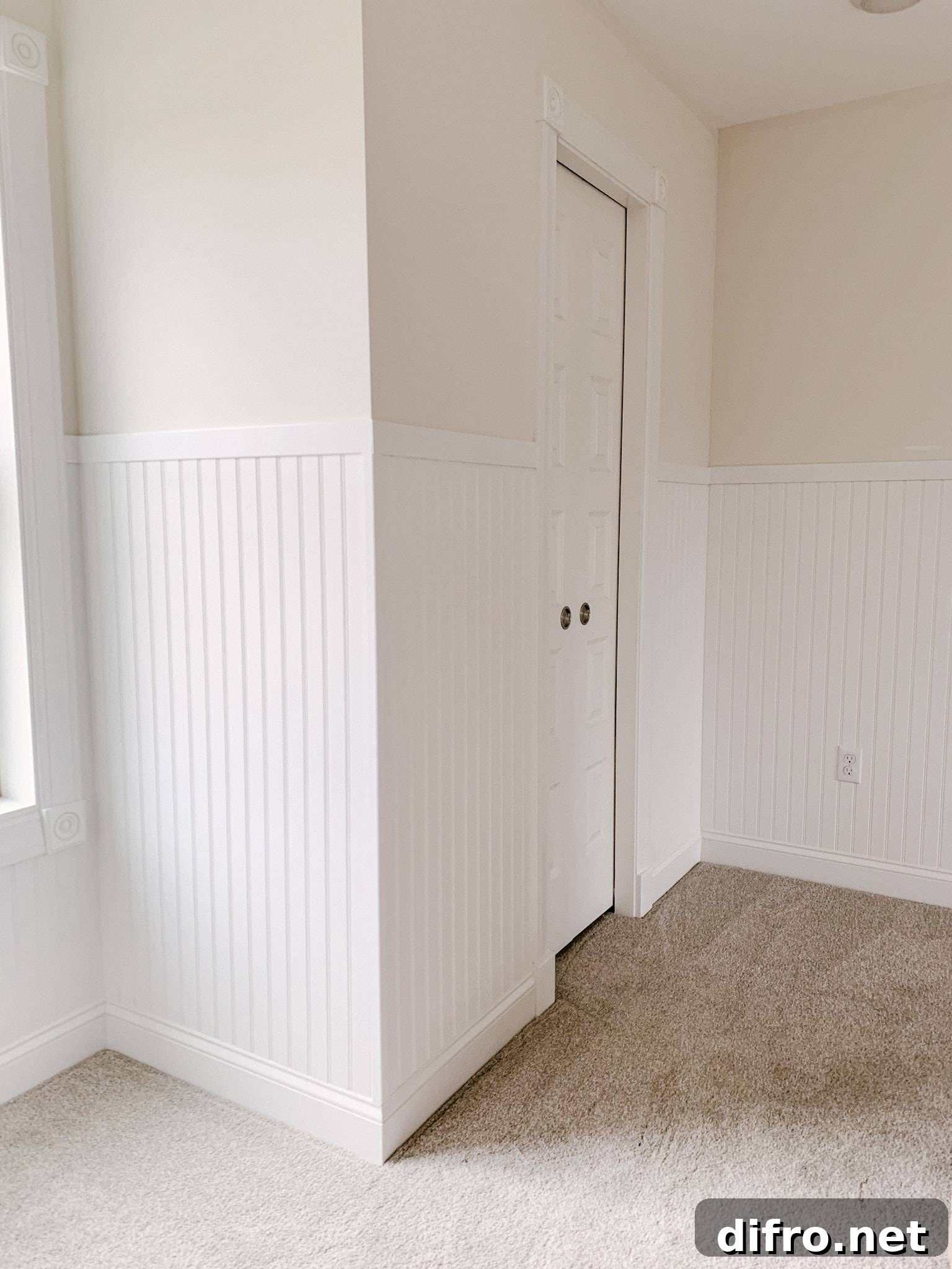 Bead-board walls in a room with carpet.